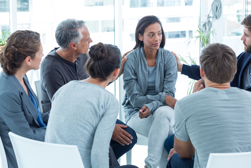 woman getting support from group