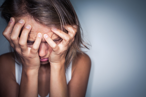 distressed woman covering face